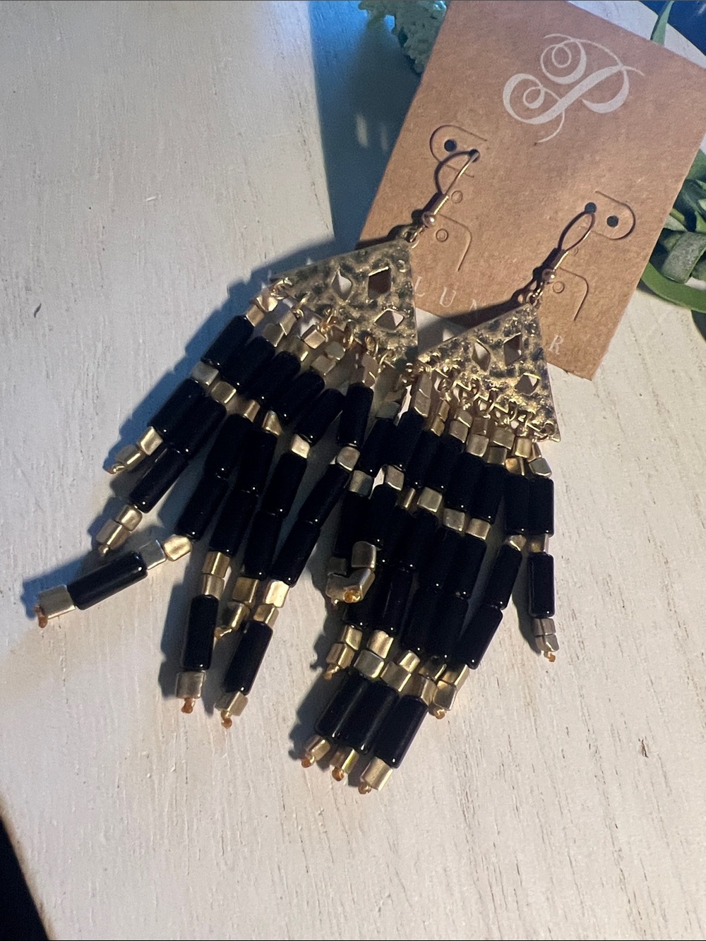 Plunder gold tone with black dangle earrings